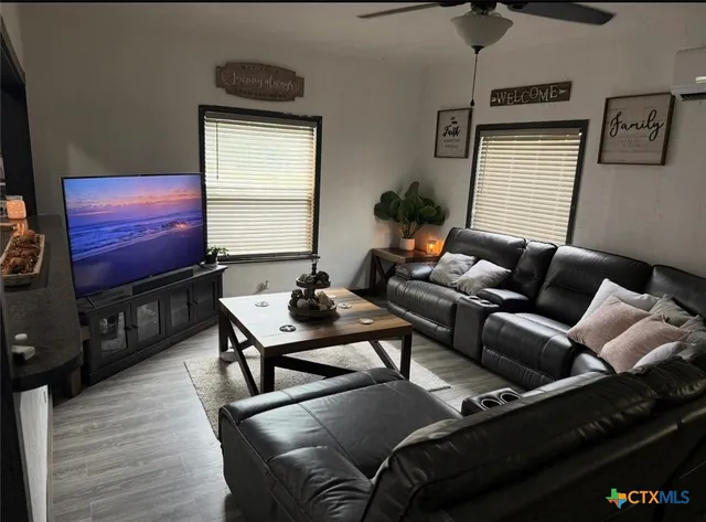 a living room with furniture and a flat screen tv