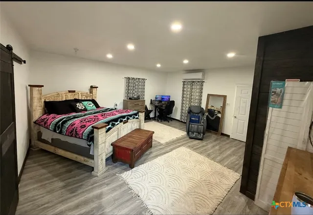 a bedroom with bed and a view of bedroom