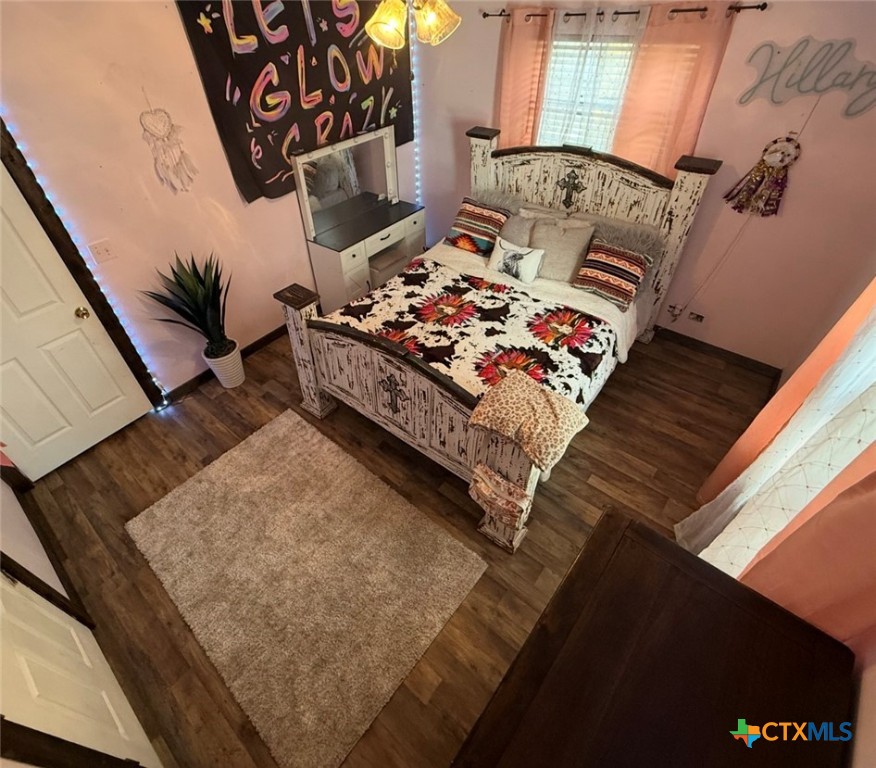202 Clark Street Yoakum, TX 77995 - Photo 10 of 15 a bed sitting in a bedroom next to a window with a rug