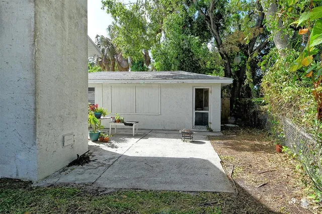 a view of house with backyard and sitting area