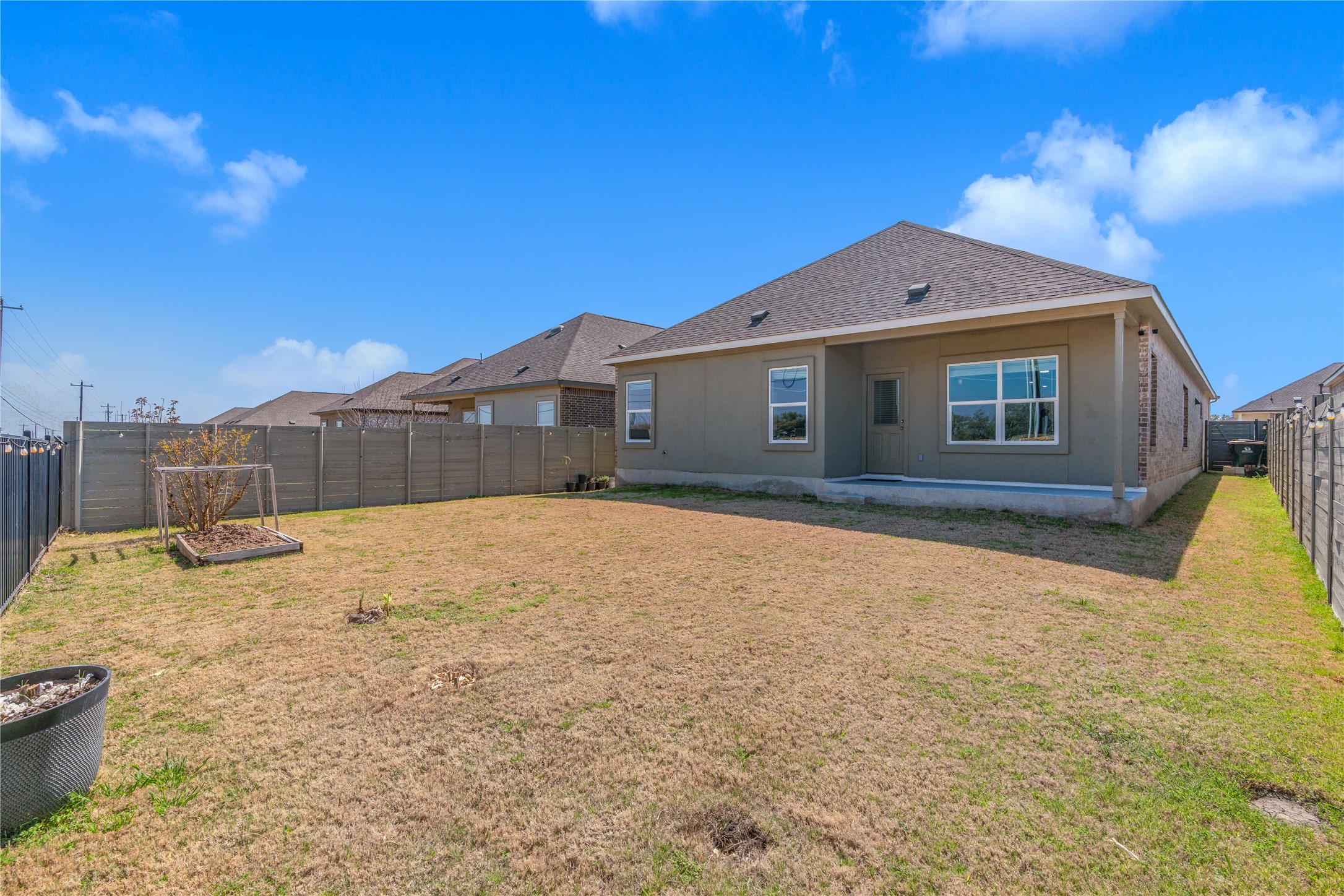 212 Saddle Mountain Road Georgetown, TX 78628 - Photo 28 of 30 A spacious backyard awaits, complete with a cozy covered patio perfect for outdoor enjoyment.