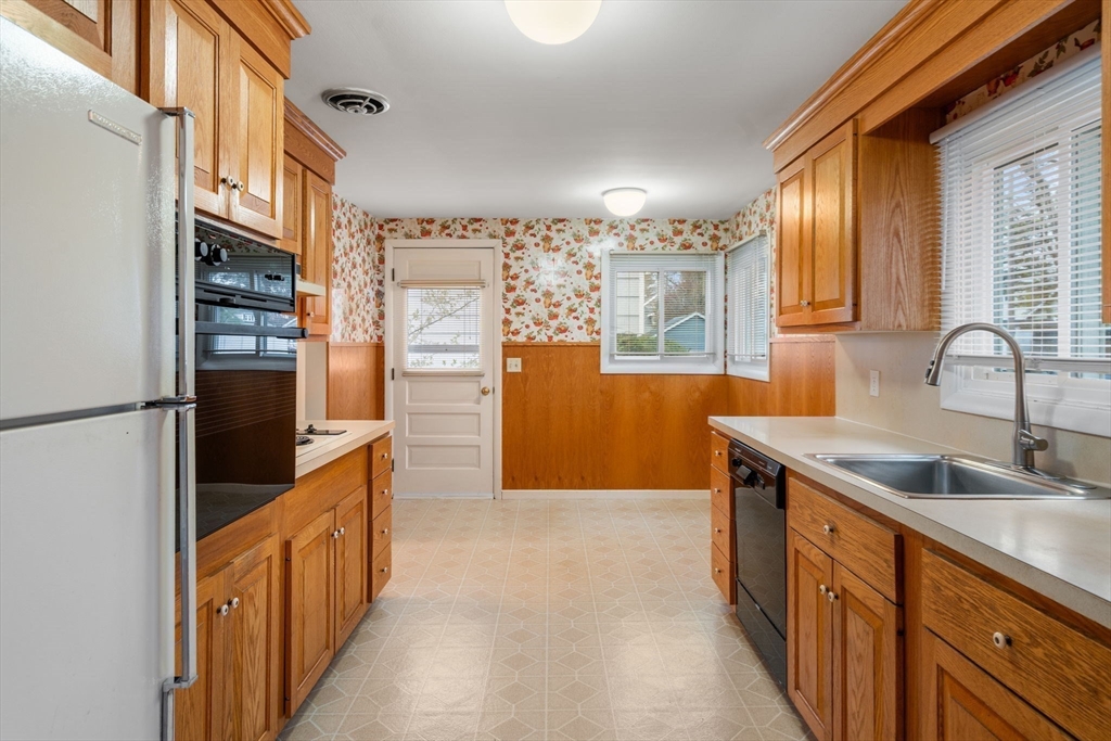 18 Royce Road Framingham, MA 01701 - Photo 11 of 30 a kitchen with stainless steel appliances granite countertop a refrigerator and a sink