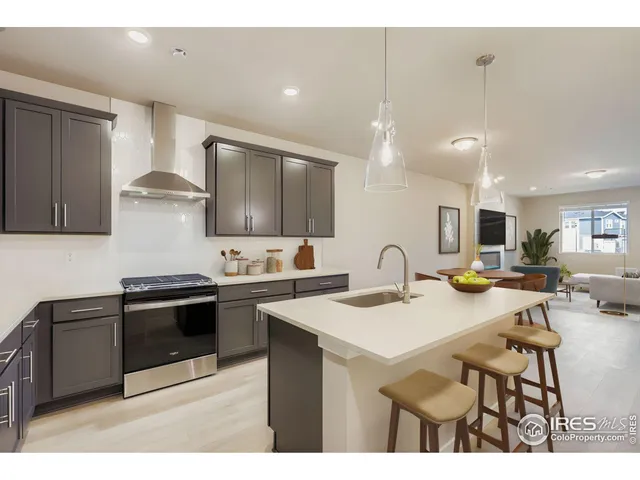 a kitchen with a sink cabinets and wooden floor