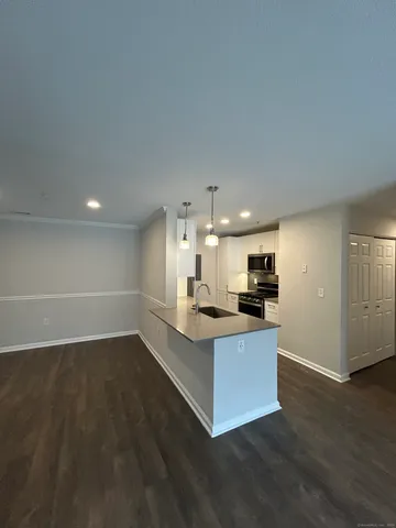 a kitchen with stainless steel appliances a sink a stove a microwave a sink and cabinets