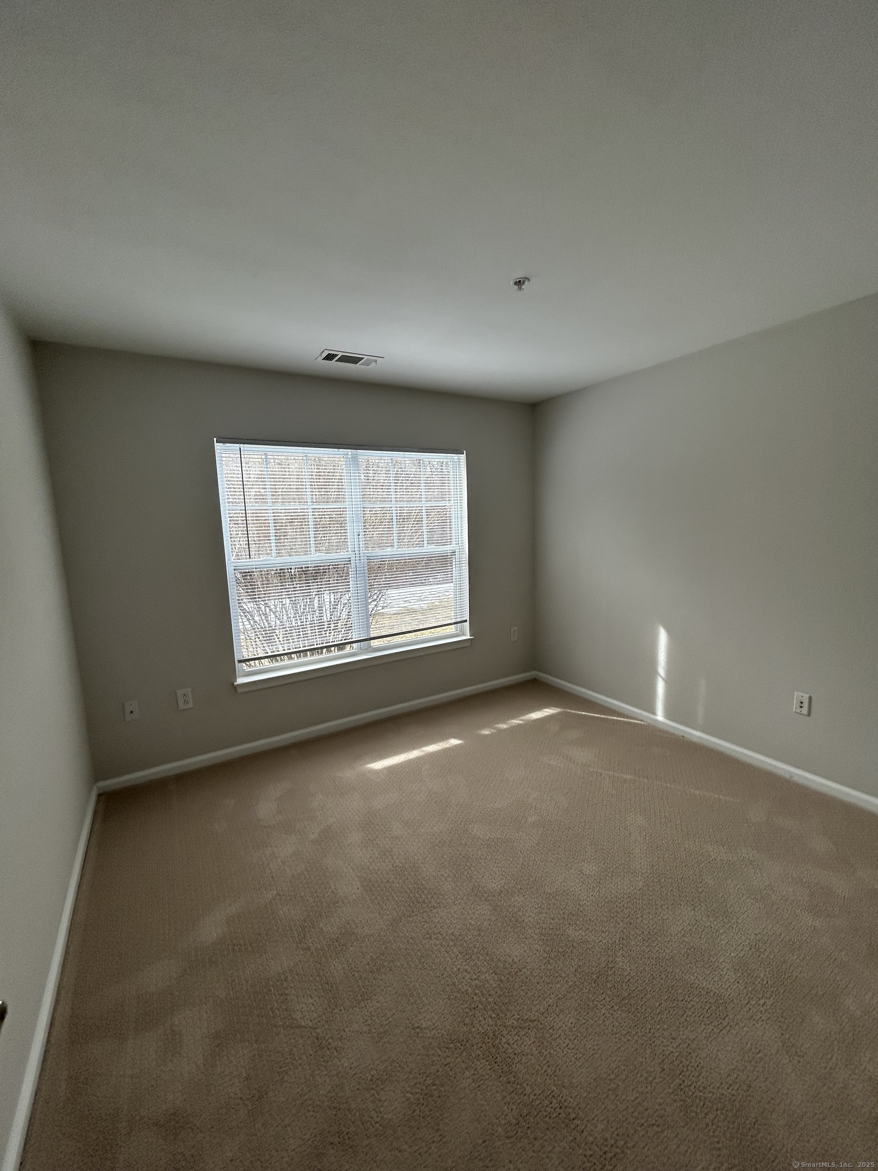 138 Hollow Tree Ridge Road, Unit 1802 Darien, CT 06820 - Photo 12 of 30 an empty room with windows