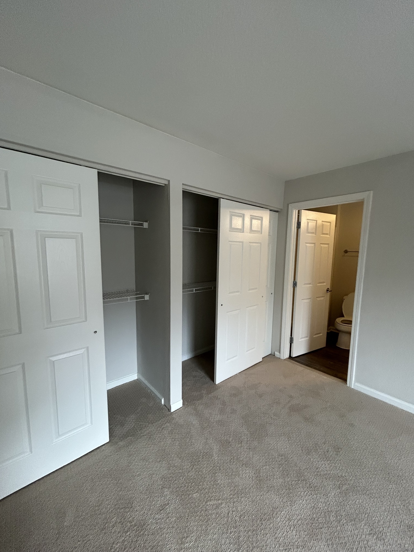 138 Hollow Tree Ridge Road, Unit 1802 Darien, CT 06820 - Photo 14 of 30 an empty room with closet