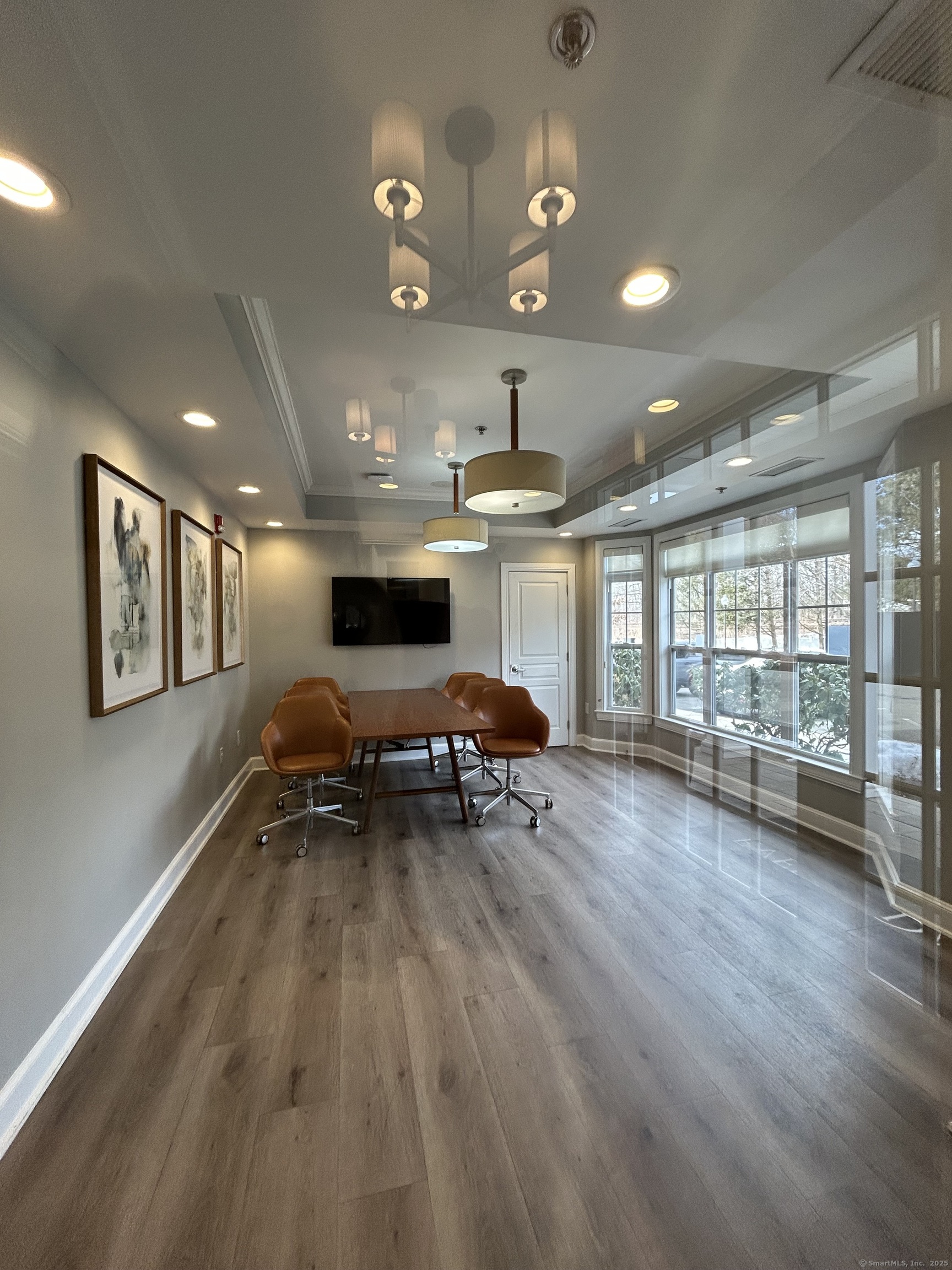 138 Hollow Tree Ridge Road, Unit 1802 Darien, CT 06820 - Photo 23 of 30 a view of a room with gym equipment and large window