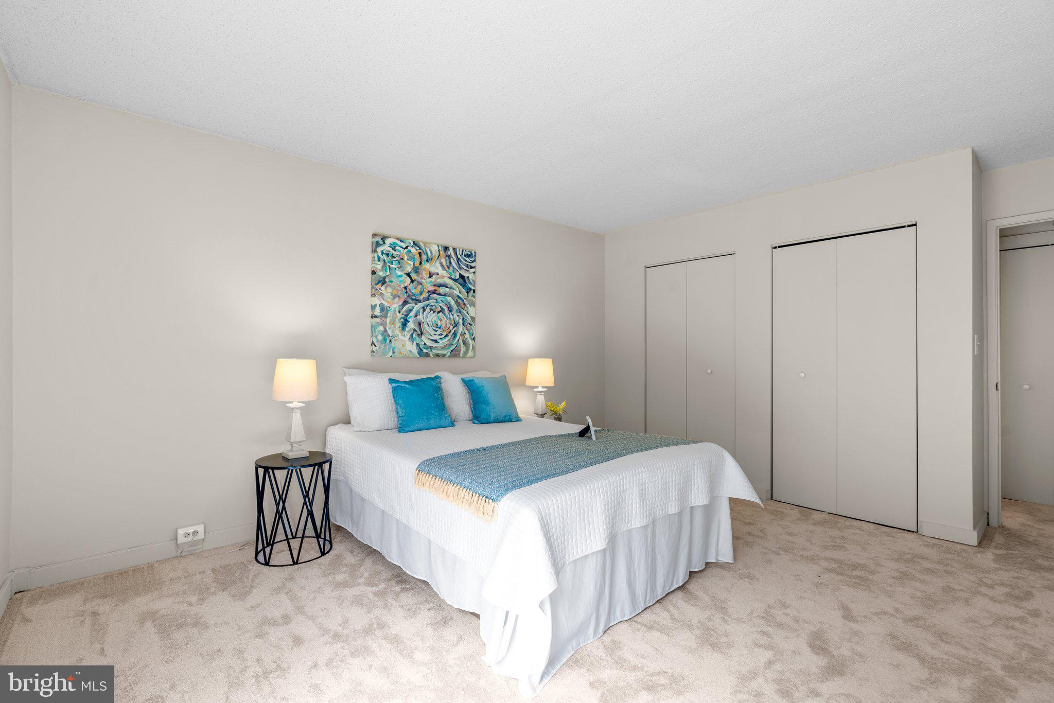 5907 Tamar Drive, Unit 7 R7 Columbia, MD 21045 - Photo 12 of 23 a bedroom with a bed and a lamp on the dresser