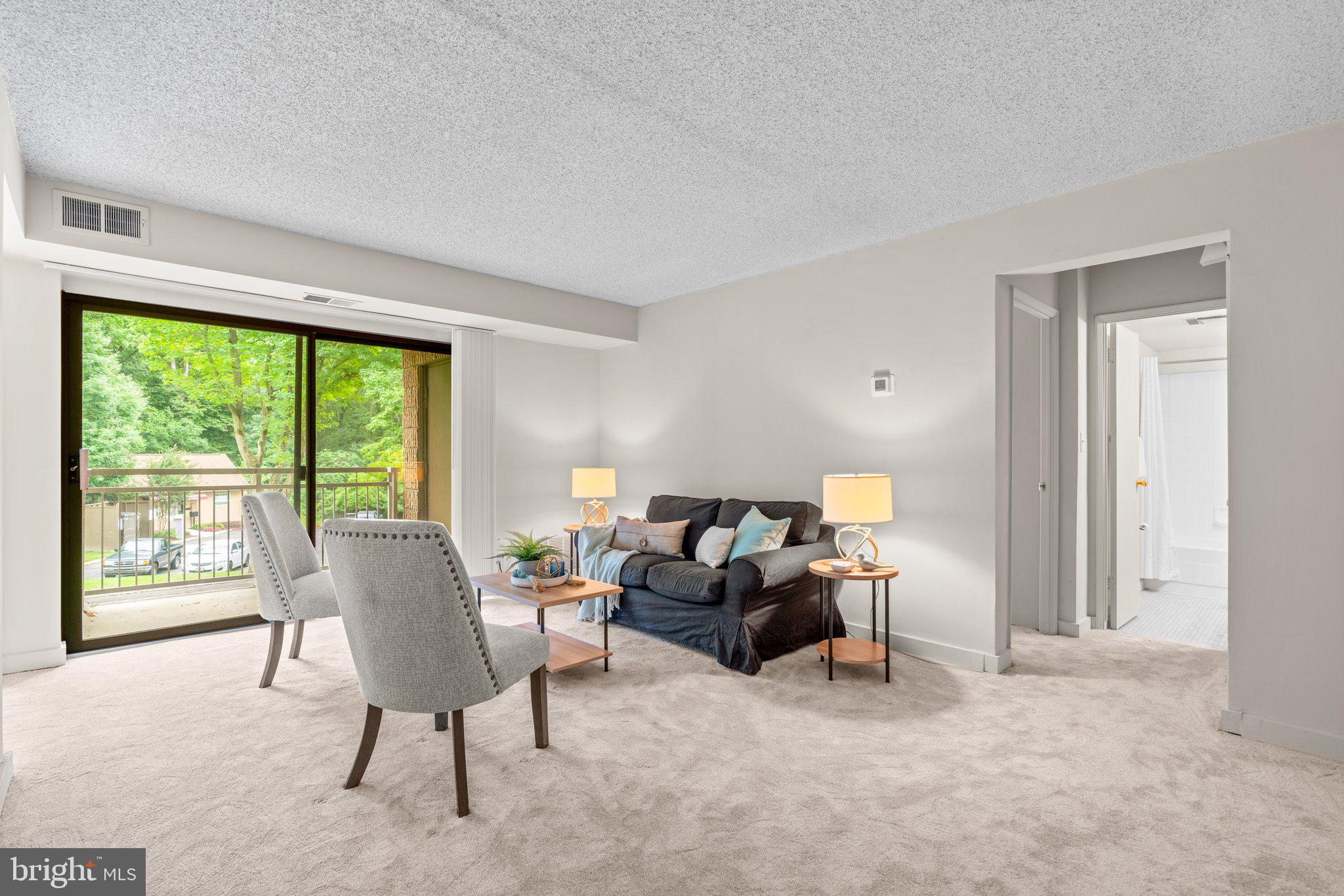 5907 Tamar Drive, Unit 7 R7 Columbia, MD 21045 - Photo 4 of 23 a living room with furniture and large windows