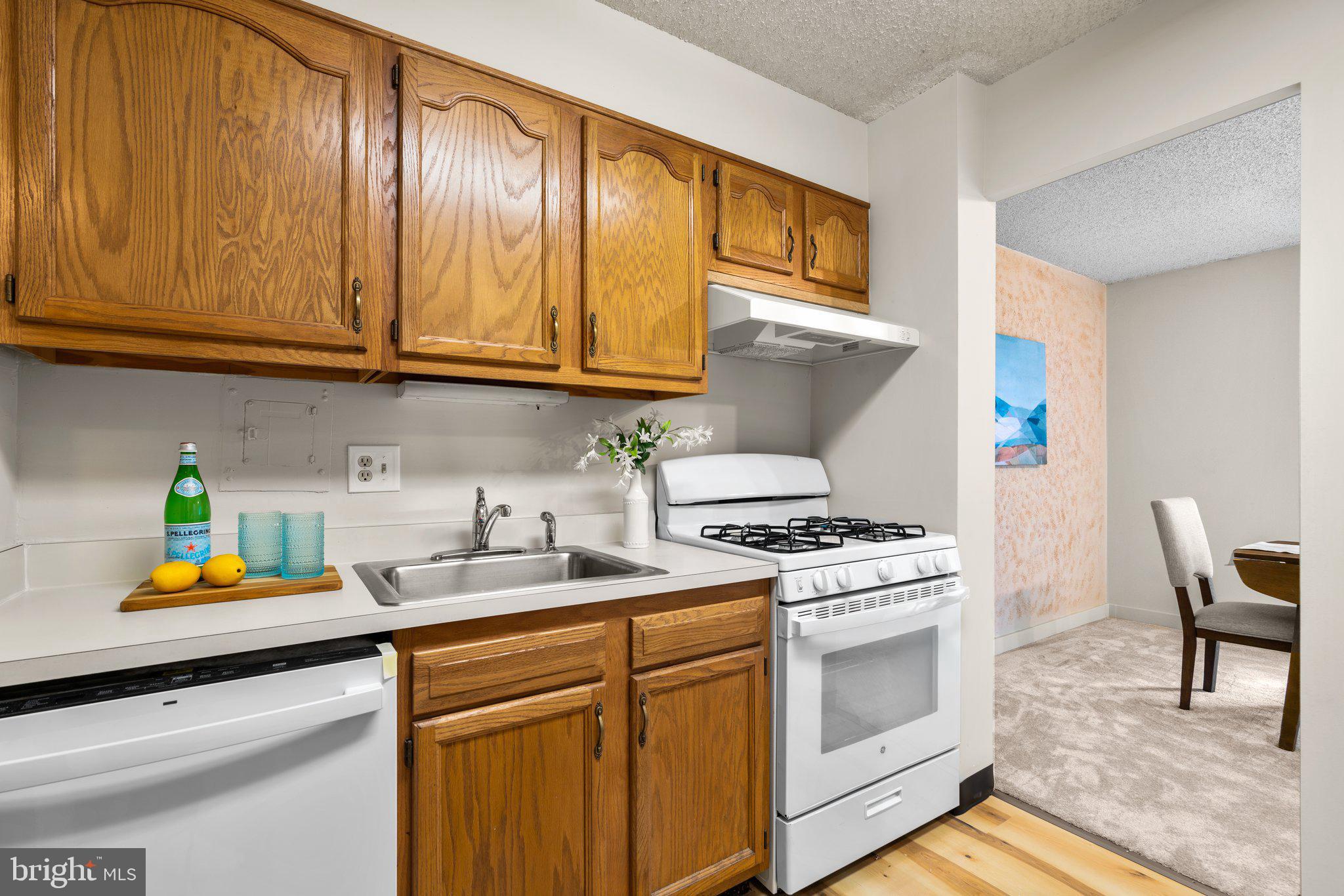 5907 Tamar Drive, Unit 7 R7 Columbia, MD 21045 - Photo 7 of 23 a kitchen with stainless steel appliances granite countertop a stove a sink and a microwave