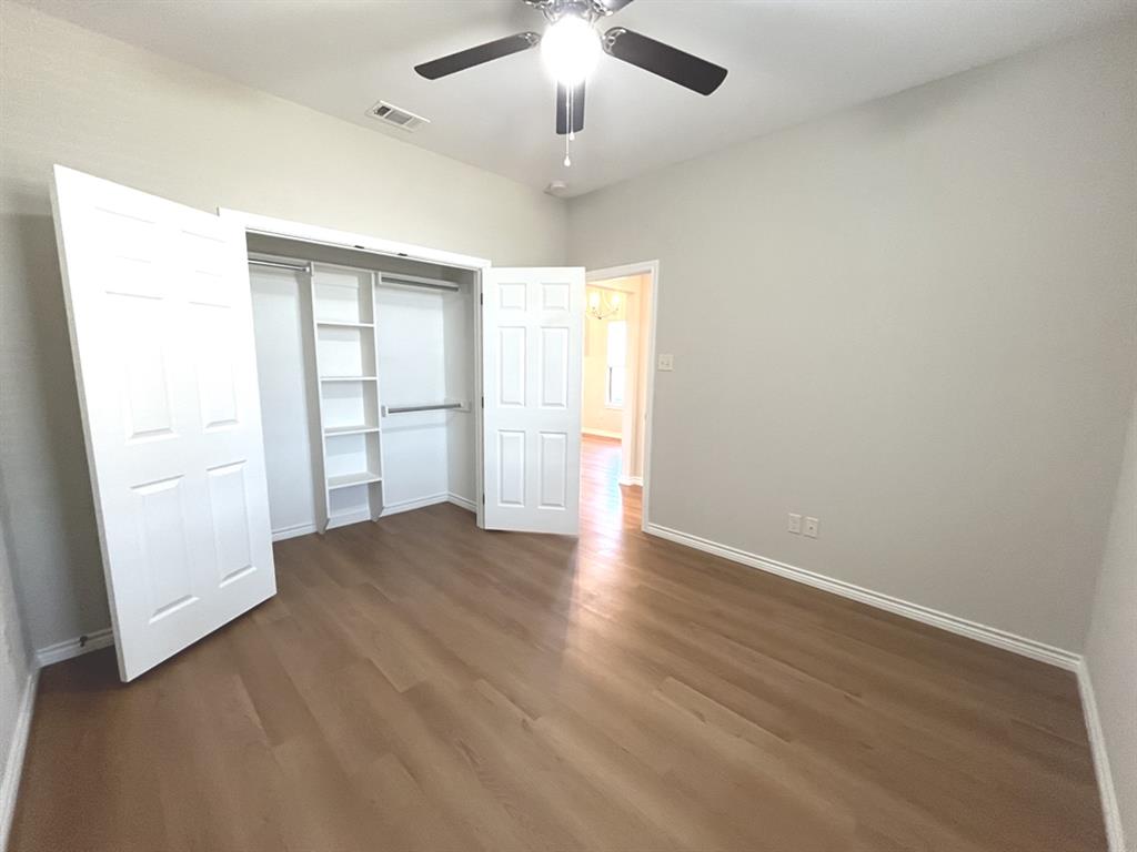 316 James Street Mabank, TX 75147 - Photo 13 of 20 wooden floor in an empty room with a window