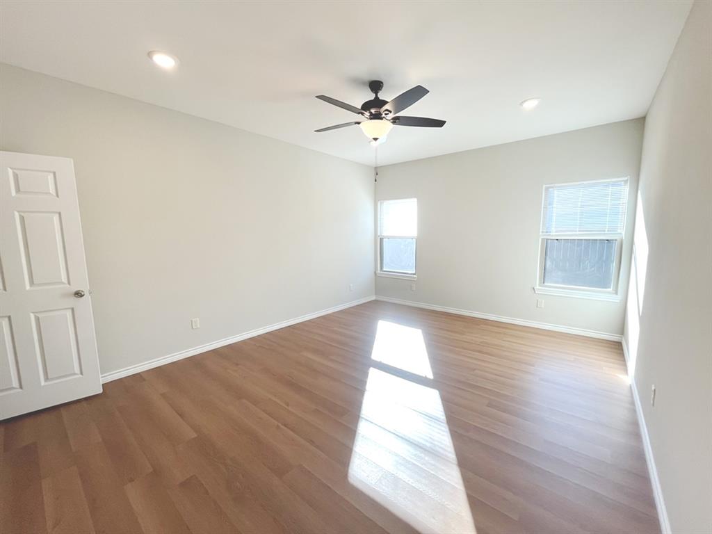 316 James Street Mabank, TX 75147 - Photo 15 of 20 an empty room with wooden floor fan and windows