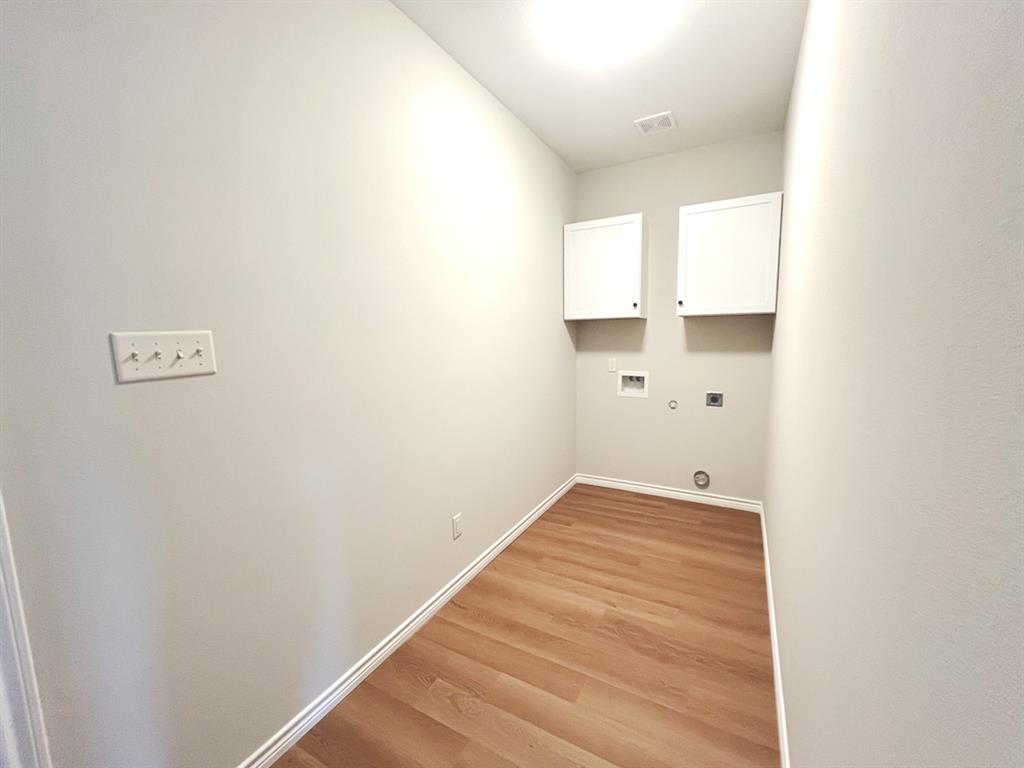 316 James Street Mabank, TX 75147 - Photo 18 of 20 a view of a room with wooden floor and white wall