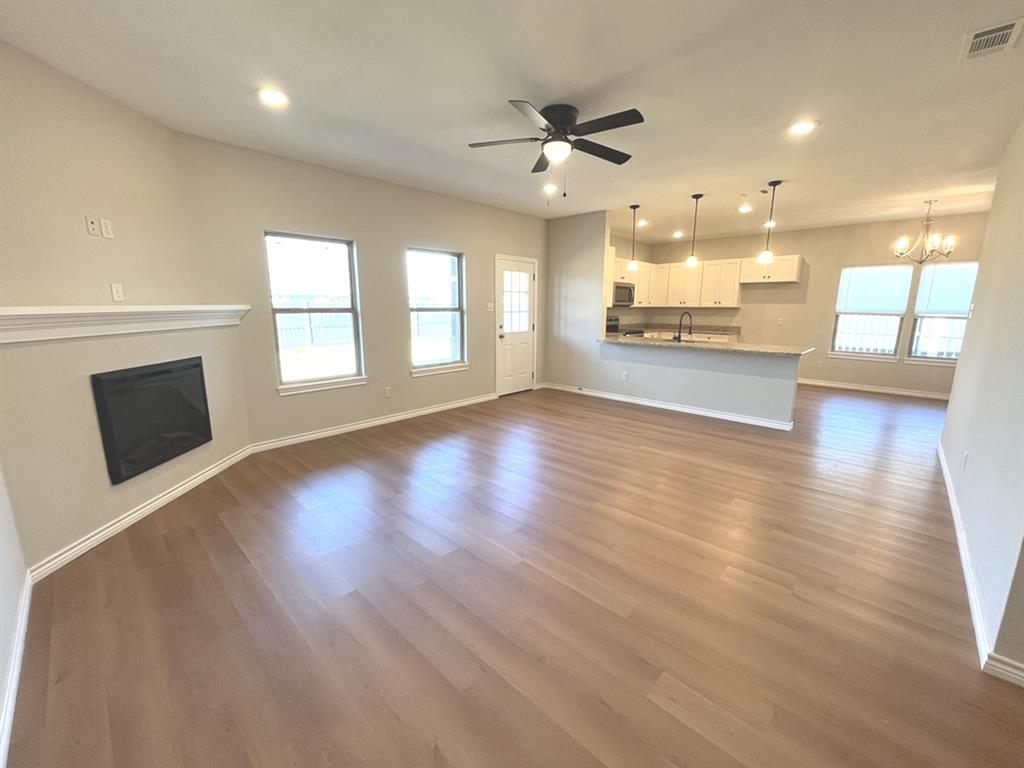 316 James Street Mabank, TX 75147 - Photo 4 of 20 an empty room with wooden floor and windows