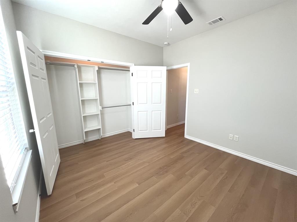 316 James Street Mabank, TX 75147 - Photo 10 of 20 wooden floor in an empty room with a window