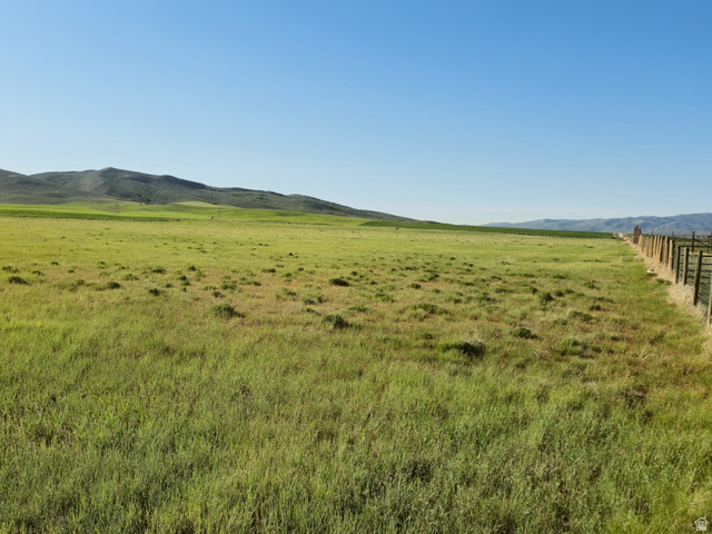1720 Lower Bern Road, Unit 8 Bern, ID 83220 - Photo 4 of 7 Expansive green fields featuring a perimeter fence and distant mountains