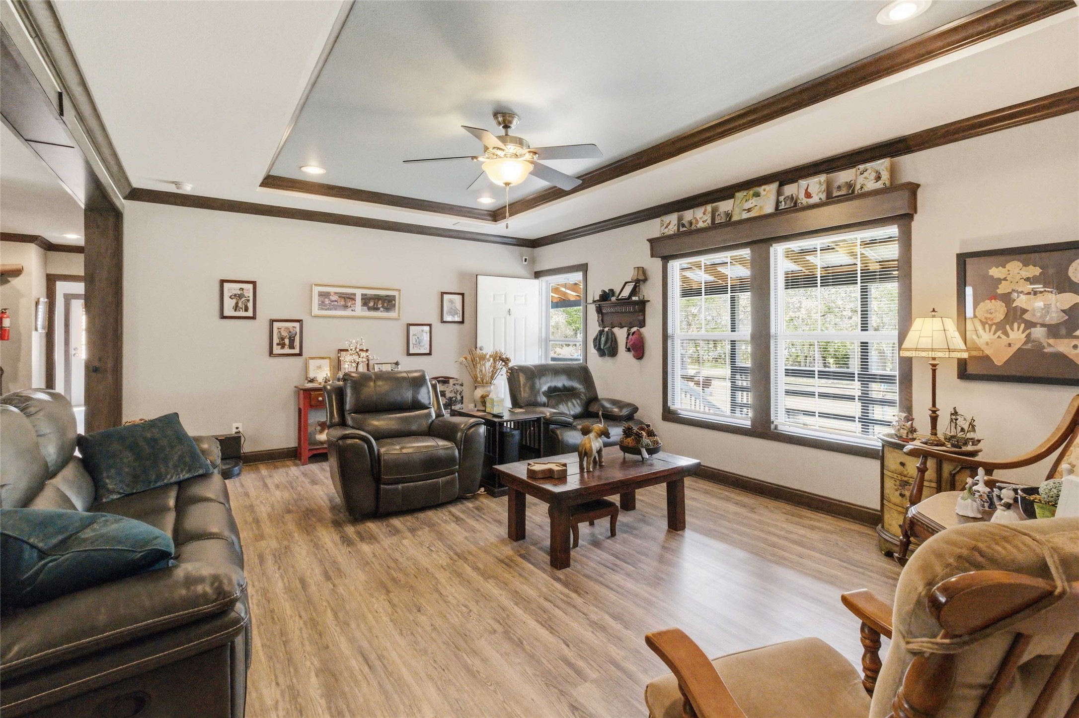7921 Vista Ranch Road Smithville, TX 78957 - Photo 8 of 39 An inviting family room offers abundant natural light and rich wood trim, creating a warm, comfortable atmosphere.