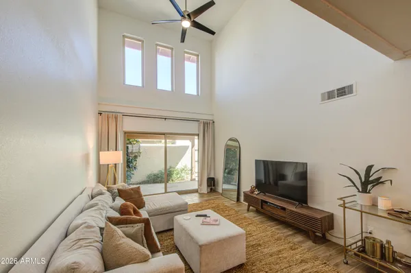a bedroom with a bed and a table in it with wooden floor