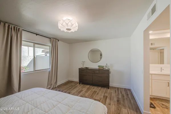 a bathroom with a toilet a sink and a mirror