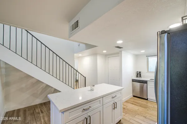 a kitchen with appliances a sink and cabinets
