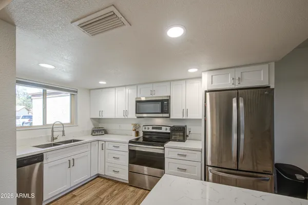 a kitchen with stainless steel appliances a refrigerator and a stove top oven