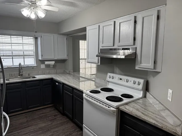 a kitchen with stainless steel appliances granite countertop a stove and a sink