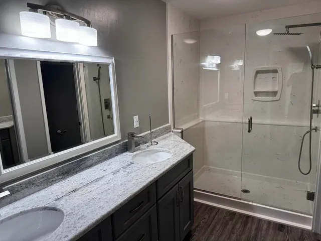 a bathroom with a granite countertop sink mirror and double
