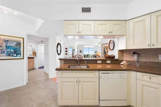 a large bed sitting in a bedroom next to a window and a lamp