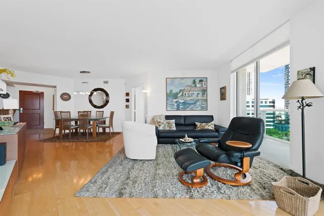 a bedroom with a bed a flat screen tv and a dresser