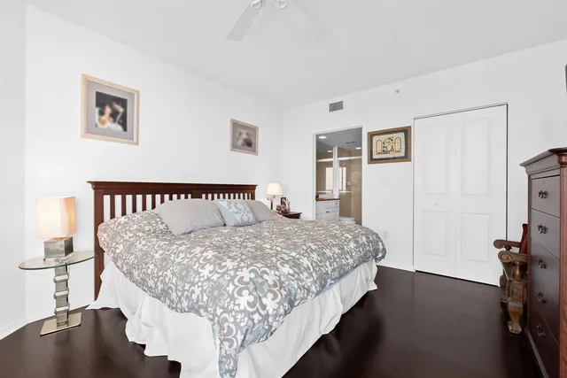 a view of a patio with table and chairs potted plants and palm trees