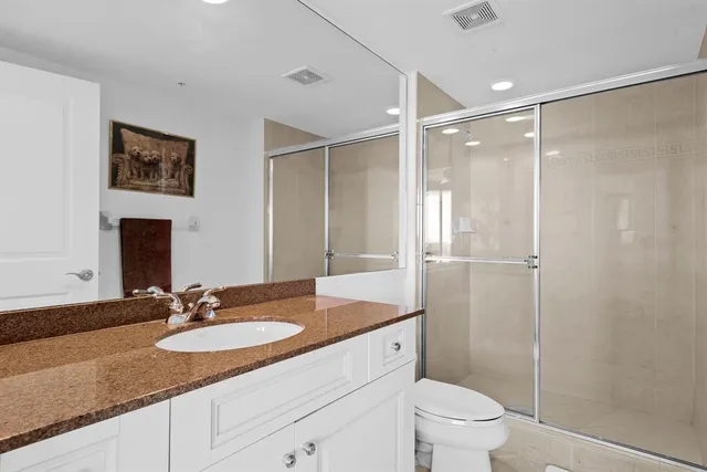a bathroom with a glass shower door