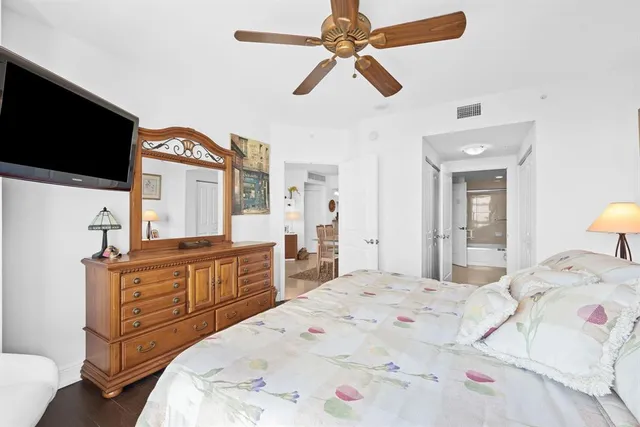 a room with furniture pool table wooden floor and windows