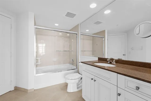 a view of a dining room with furniture and a chandelier
