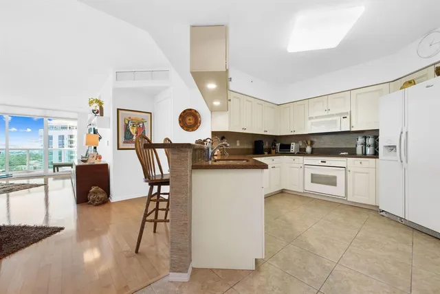 a living room with furniture a rug and a window