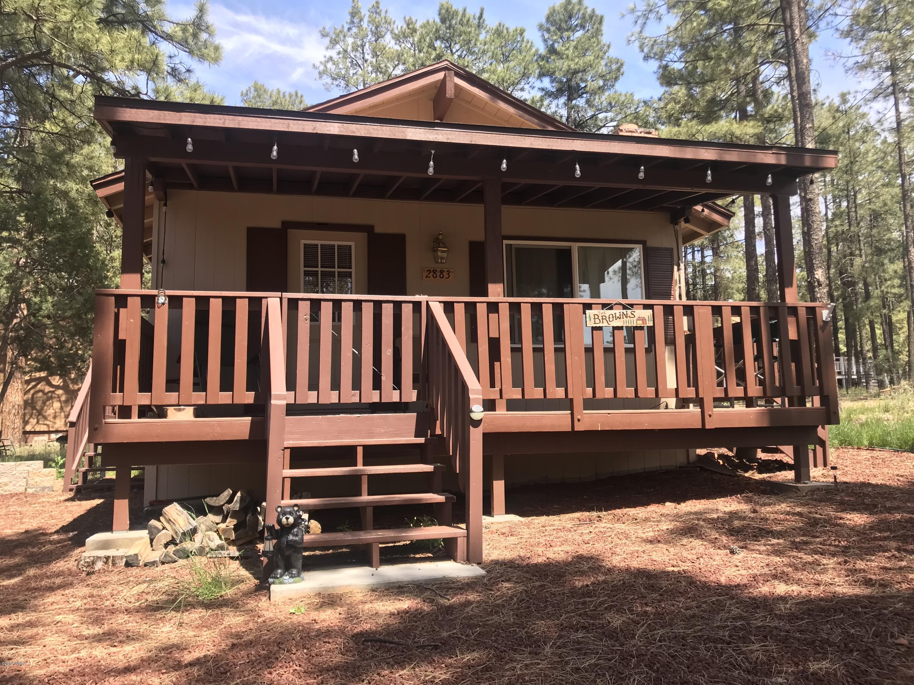 a view of a house with a yard balcony and wooden fence