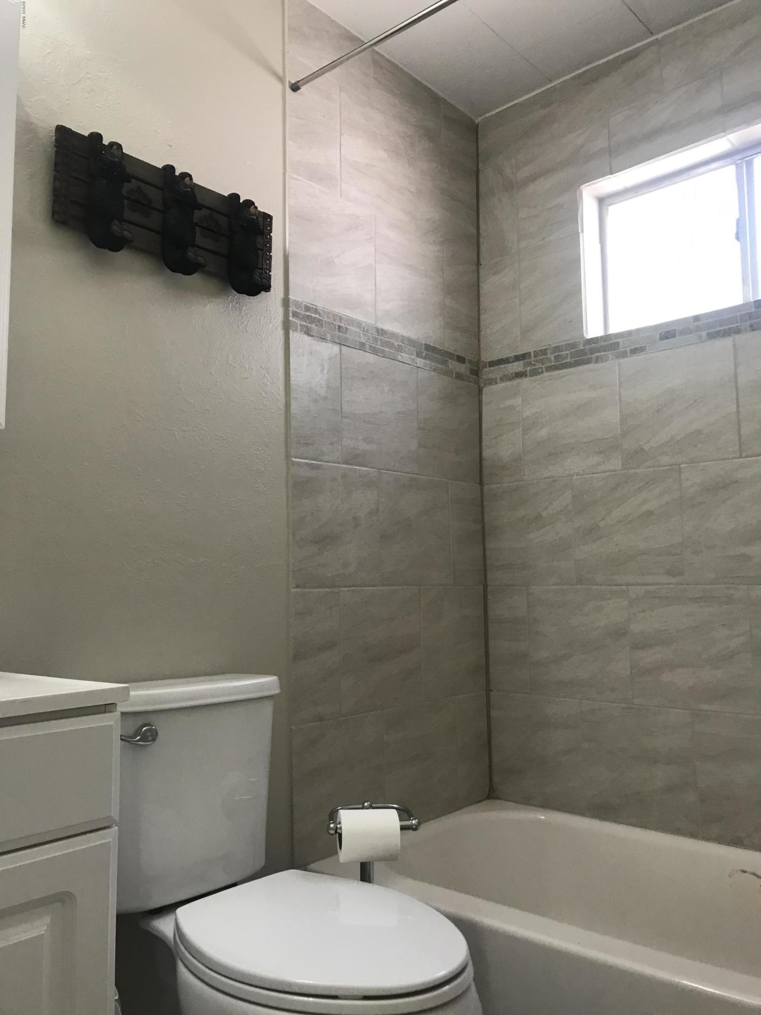 2883 Belle Road Overgaard, AZ 85933 - Photo 7 of 13 a white toilet sitting next to a bath tub