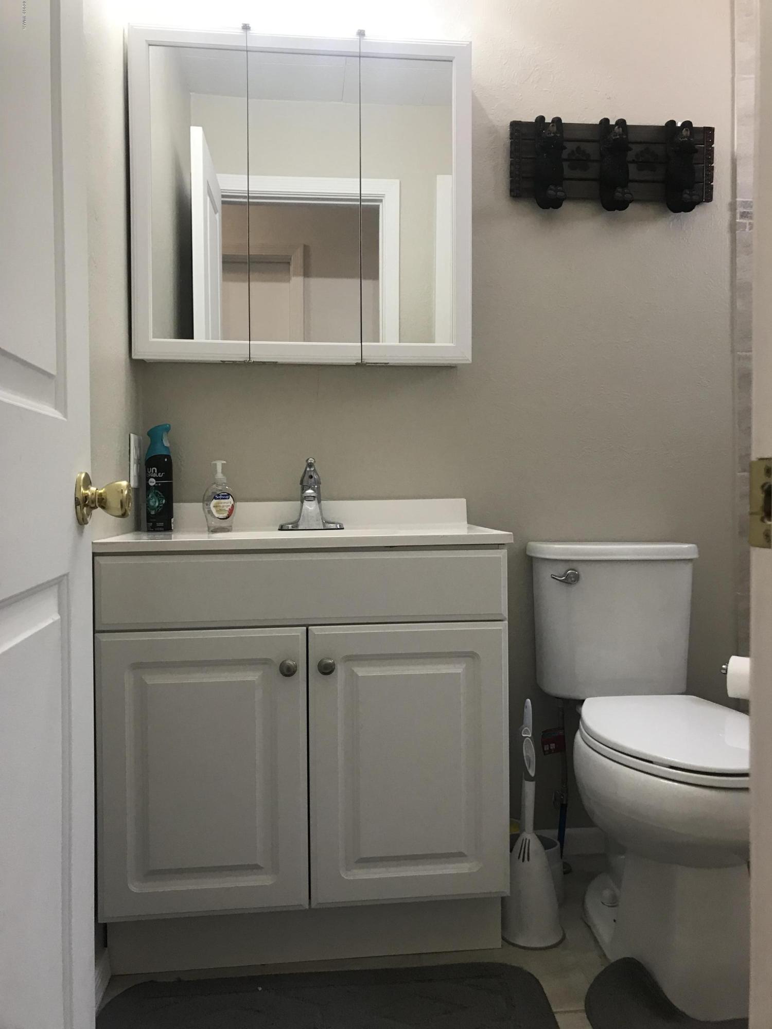 2883 Belle Road Overgaard, AZ 85933 - Photo 8 of 13 a bathroom with a sink a toilet and mirror