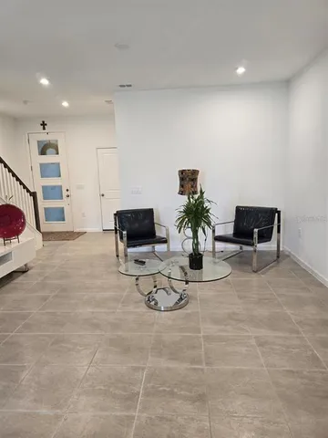 a living room with furniture and a potted plant