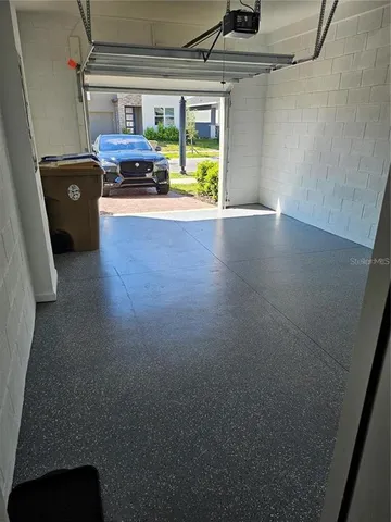 a view of a room with wooden floor and windows
