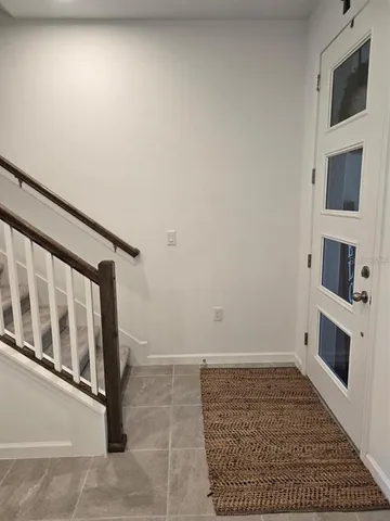a view of an empty room with a fireplace and a window