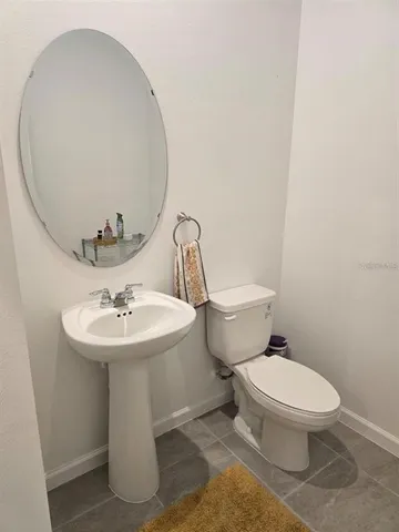 a white toilet sitting next to a bathroom sink