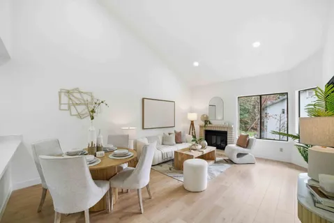 a living room with fireplace furniture and a wooden floor