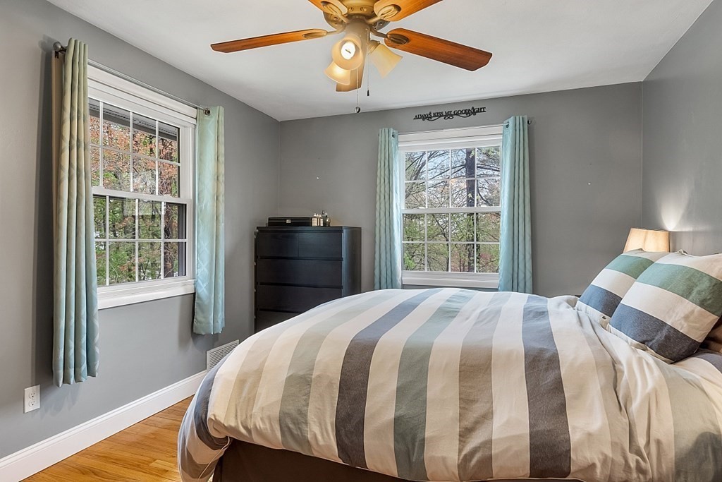13 Clinton Road Peabody, MA 01960 - Photo 12 of 39 a bedroom with a bed and a chandelier