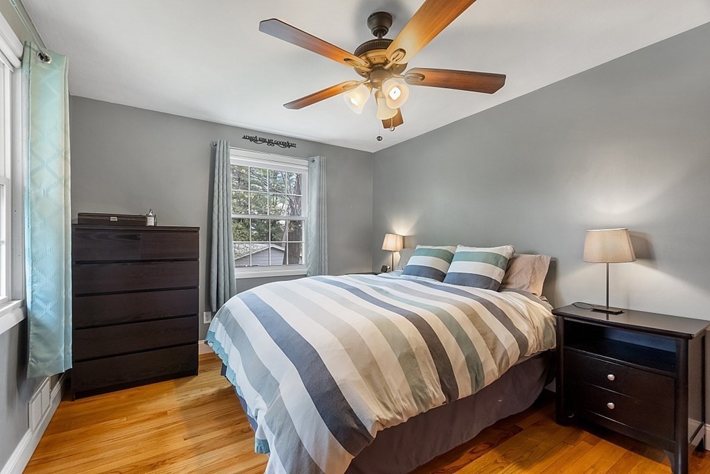 13 Clinton Road Peabody, MA 01960 - Photo 13 of 39 a bedroom with a bed and a chandelier