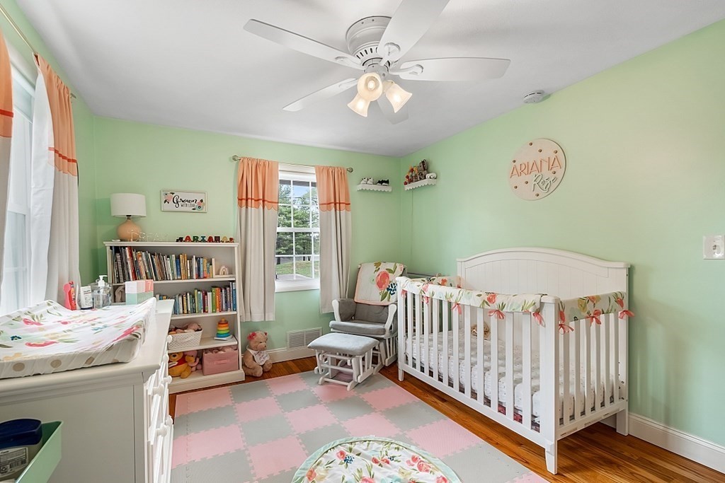 13 Clinton Road Peabody, MA 01960 - Photo 16 of 39 a bedroom with a baby bed a chandelier and a book shelf