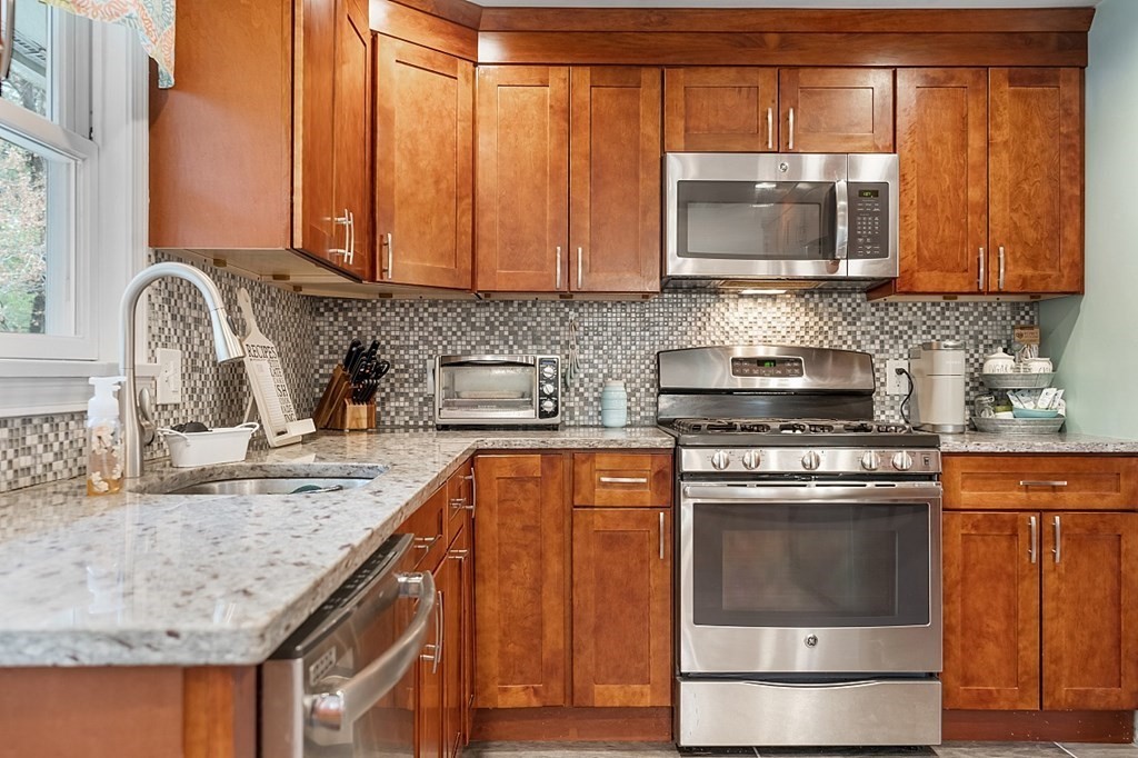 13 Clinton Road Peabody, MA 01960 - Photo 5 of 39 a kitchen with stainless steel appliances granite countertop a sink stove and microwave
