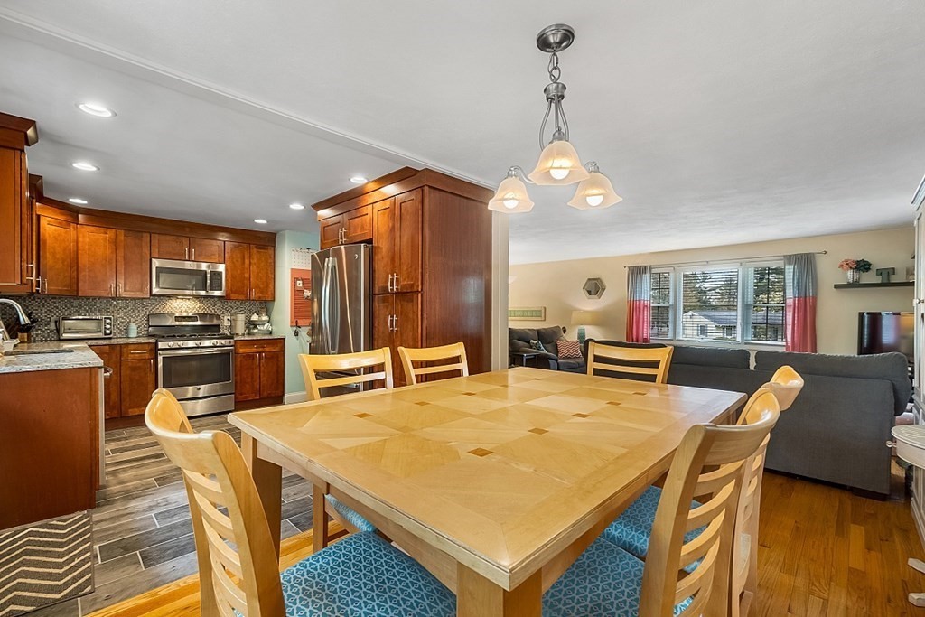13 Clinton Road Peabody, MA 01960 - Photo 6 of 39 a dining table with chairs and kitchen view