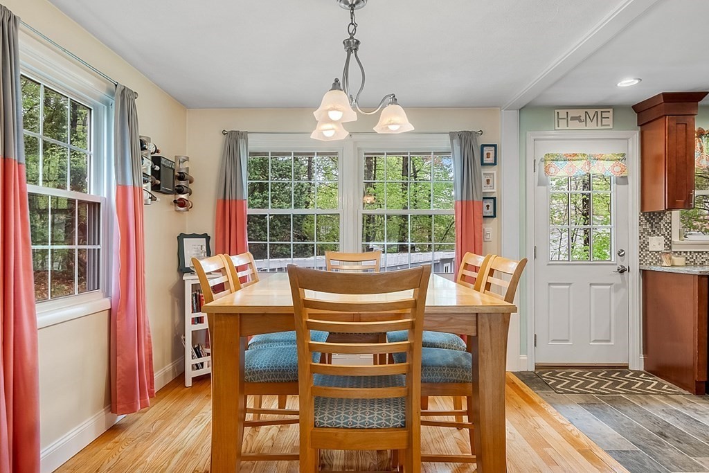 13 Clinton Road Peabody, MA 01960 - Photo 9 of 39 a dining room with furniture a chandelier and wooden floor