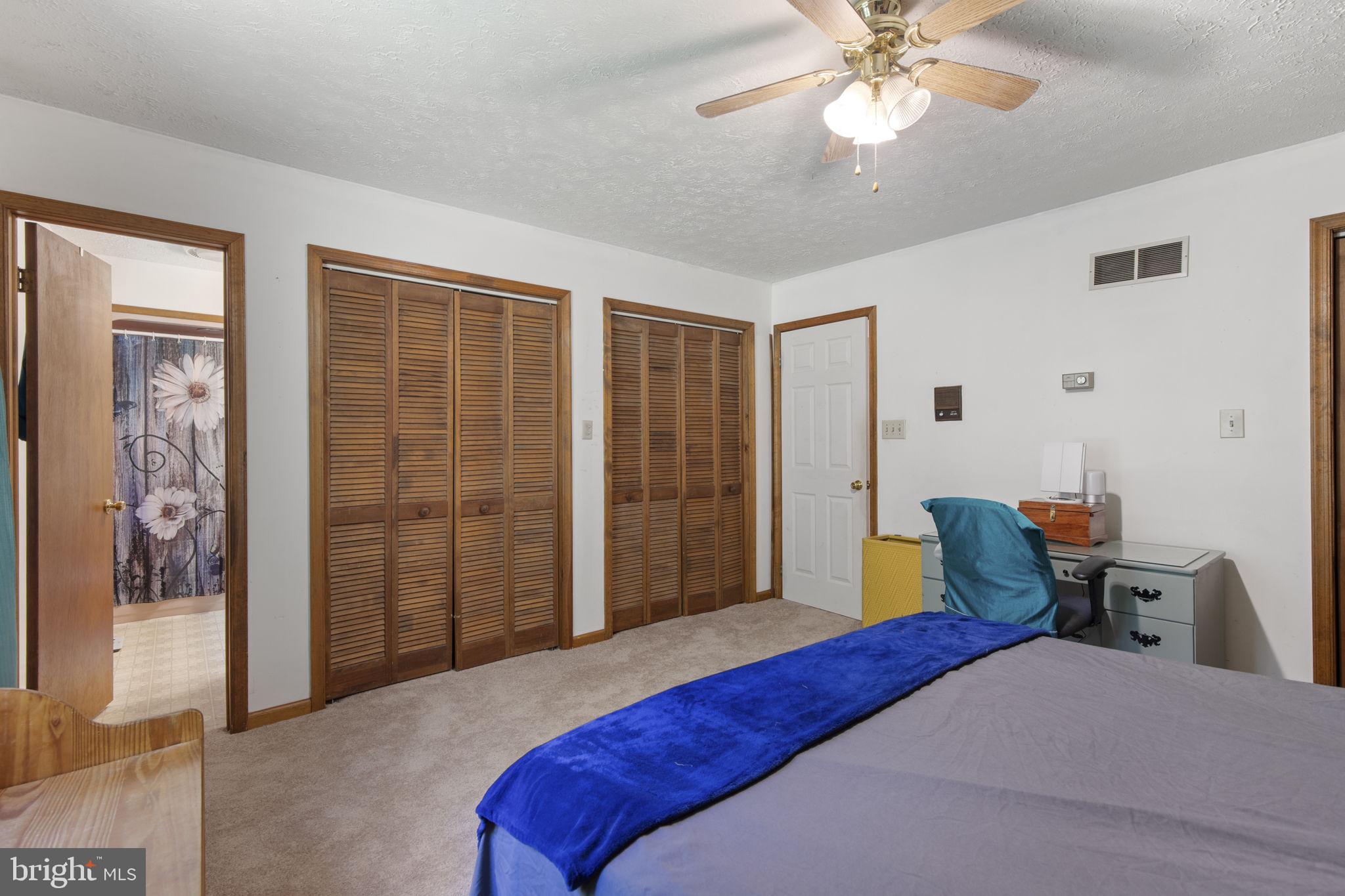 62 Porters Bridge Road Colora, MD 21917 - Photo 11 of 29 a bedroom with a bed and a chandelier