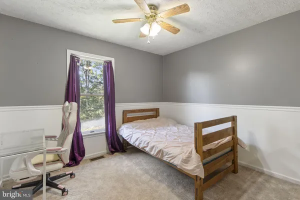 a bedroom with bed and a window